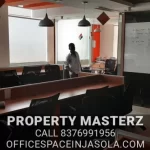 Exterior view of premium office space for sale in jasola with modern glass facade.