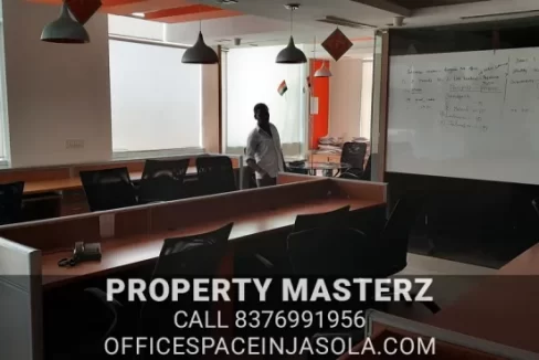 Exterior view of premium office space for sale in jasola with modern glass facade.