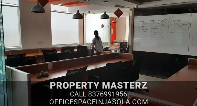 Exterior view of premium office space for sale in jasola with modern glass facade.