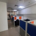 Bright, fully furnished 10-seater commercial office workspace in Jasola District Centre with modern desks and ergonomic chairs.