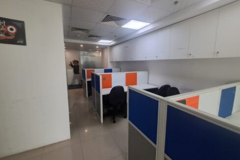 Bright, fully furnished 10-seater commercial office workspace in Jasola District Centre with modern desks and ergonomic chairs.