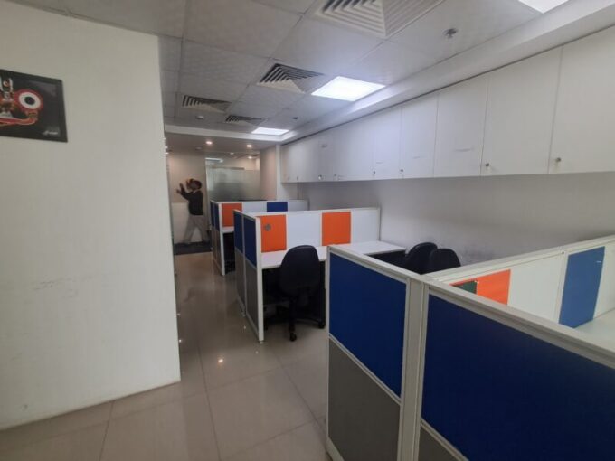 Bright, fully furnished 10-seater commercial office workspace in Jasola District Centre with modern desks and ergonomic chairs.