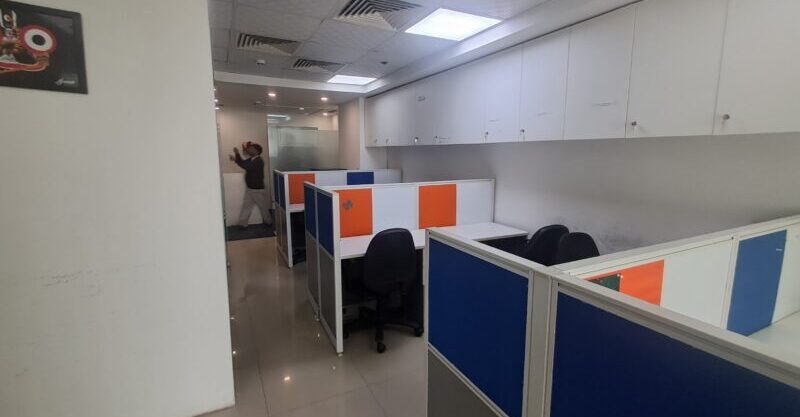 Bright, fully furnished 10-seater commercial office workspace in Jasola District Centre with modern desks and ergonomic chairs.