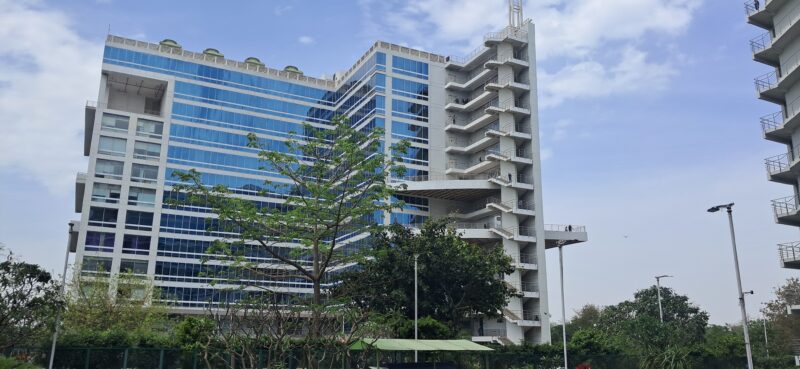 Exterior glass facade of DLF Tower A in Jasola District Centre, showcasing premium Grade-A corporate architecture and infrastructure.